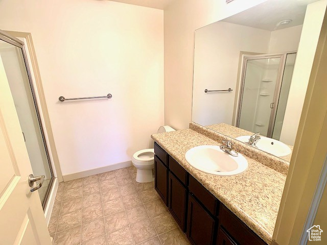 Full bath featuring a shower stall and vanity