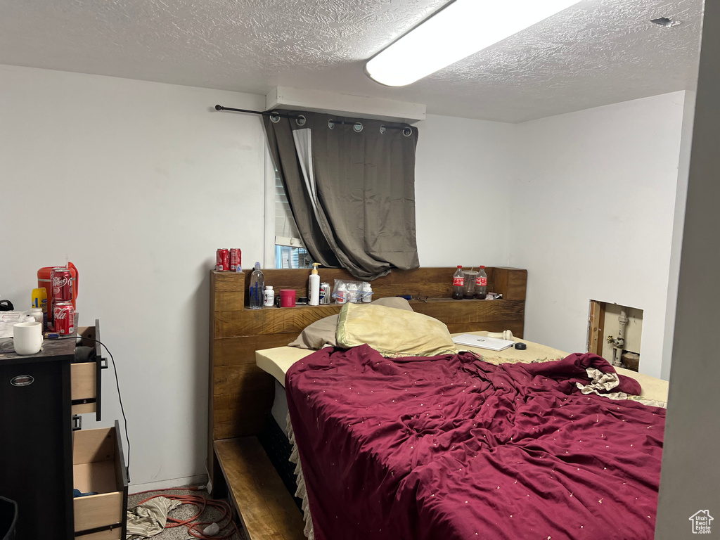 Bedroom featuring a textured ceiling