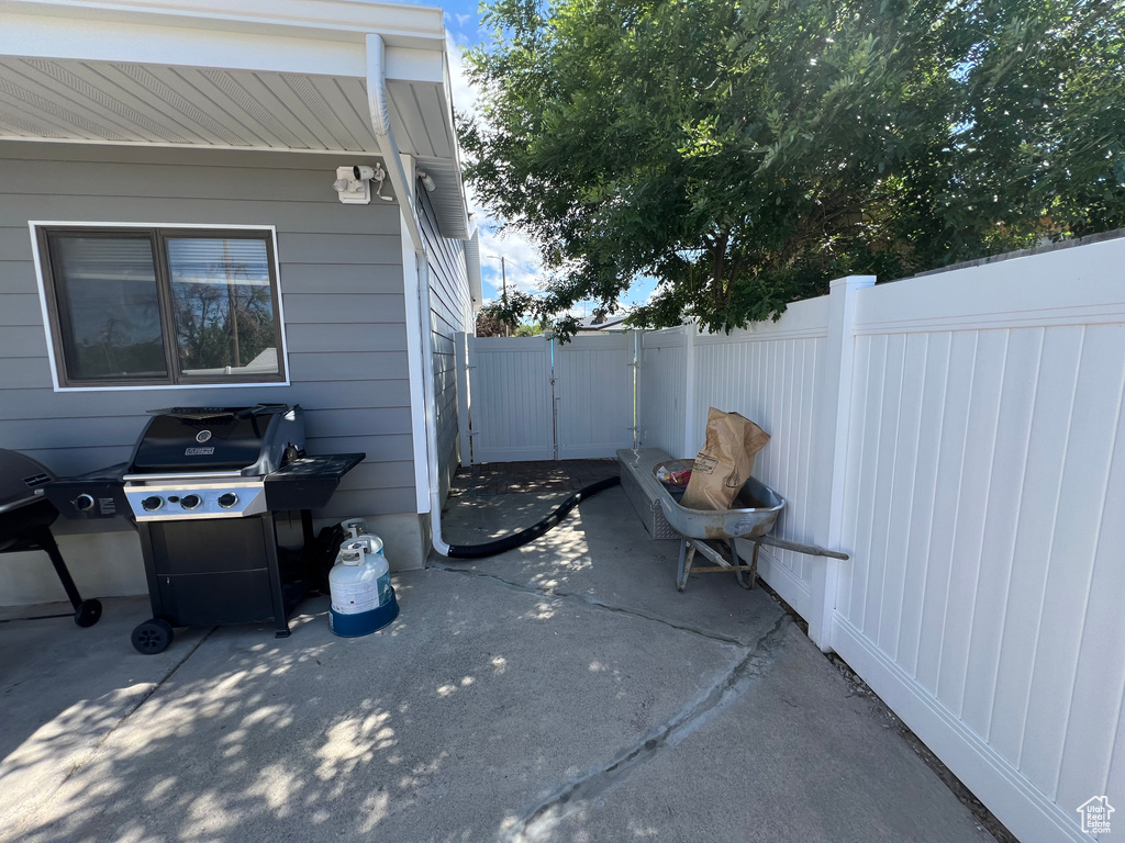 View of patio with grilling area and a gate