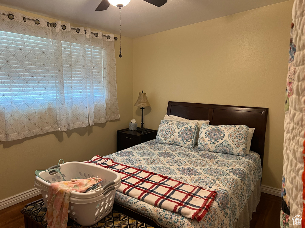 Bedroom with wood finished floors and a ceiling fan