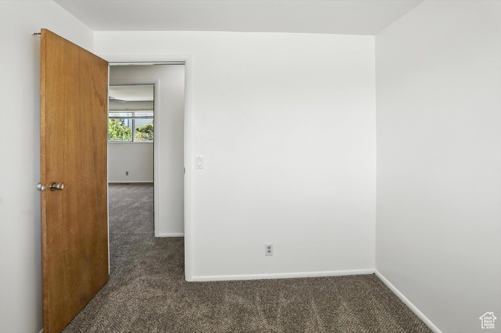 Carpeted spare room with baseboards