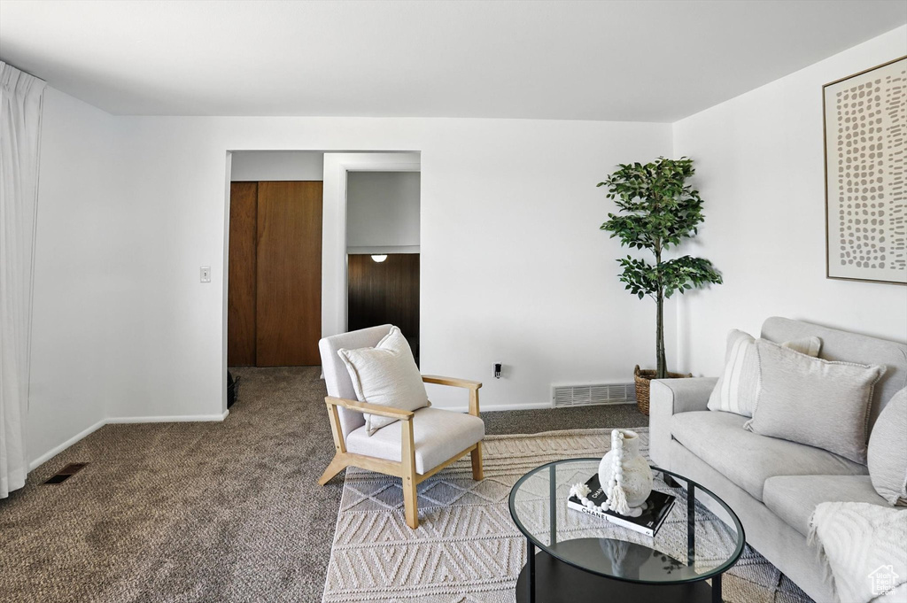 Carpeted living room with baseboards