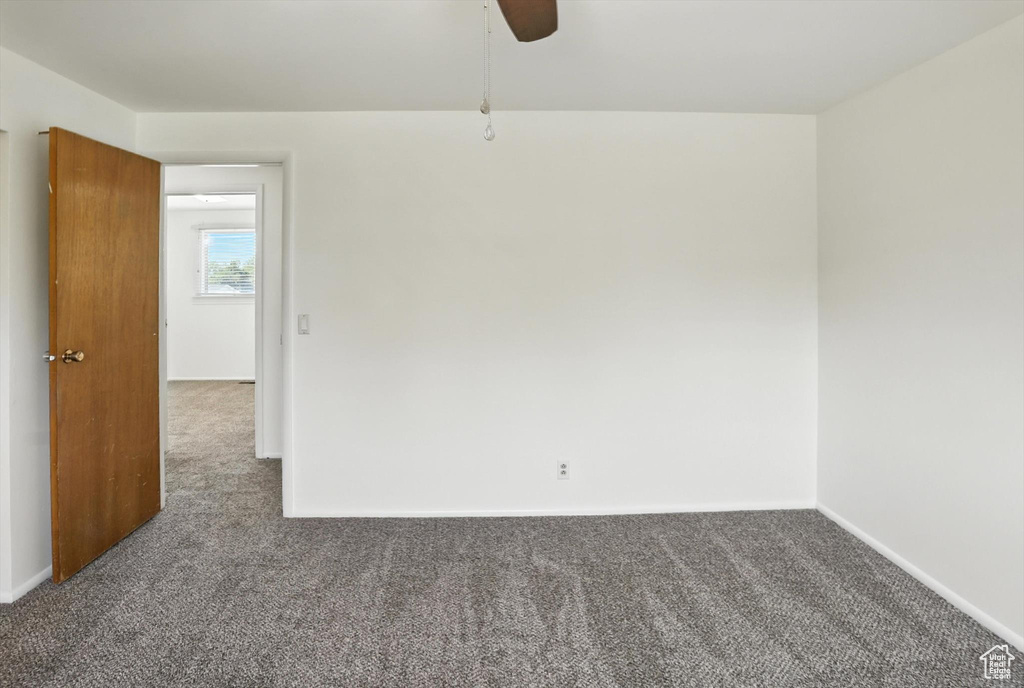 Unfurnished room featuring carpet flooring and ceiling fan
