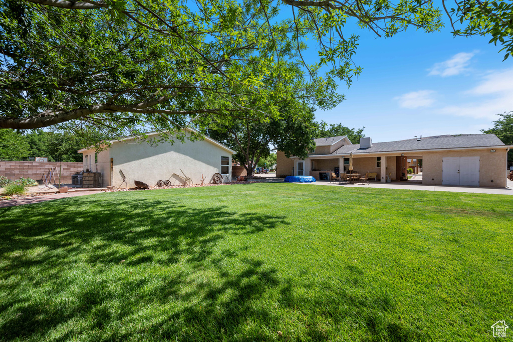 View of green lawn featuring a patio area
