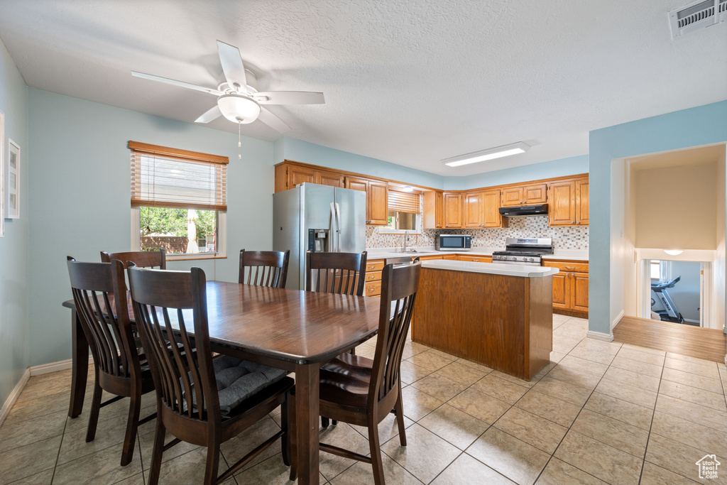 Dining room featuring a ceiling fan and light tile patterned floors