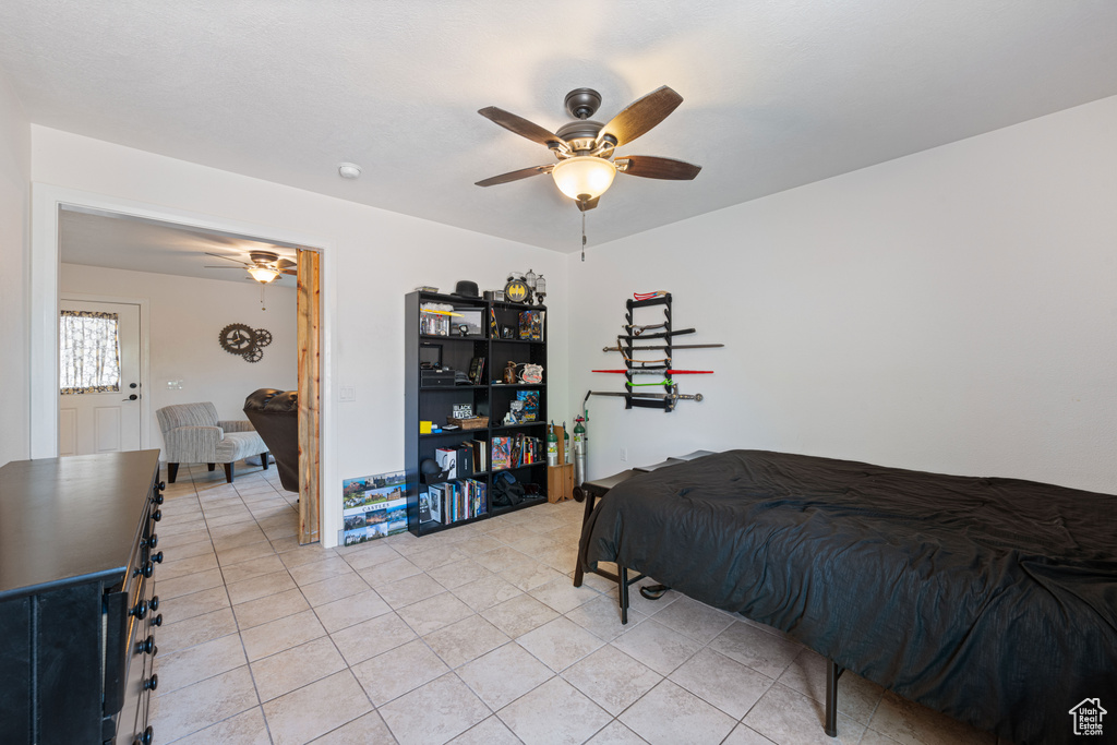 Bedroom featuring light tile patterned flooring and a ceiling fan