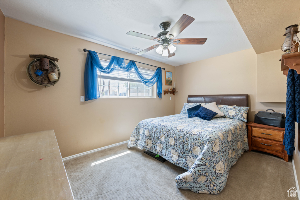 Bedroom with carpet and a ceiling fan