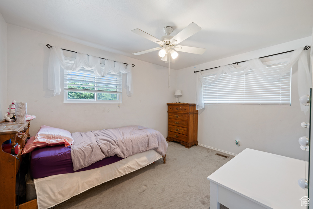 Bedroom featuring light carpet and ceiling fan