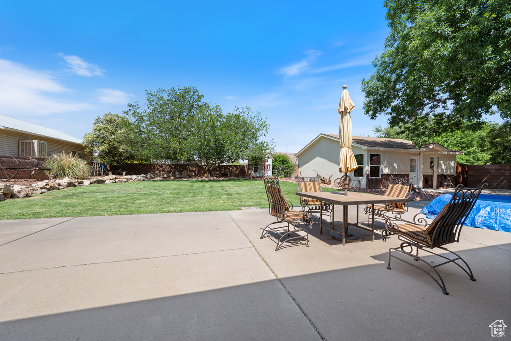 Fenced backyard featuring a patio and outdoor dining space