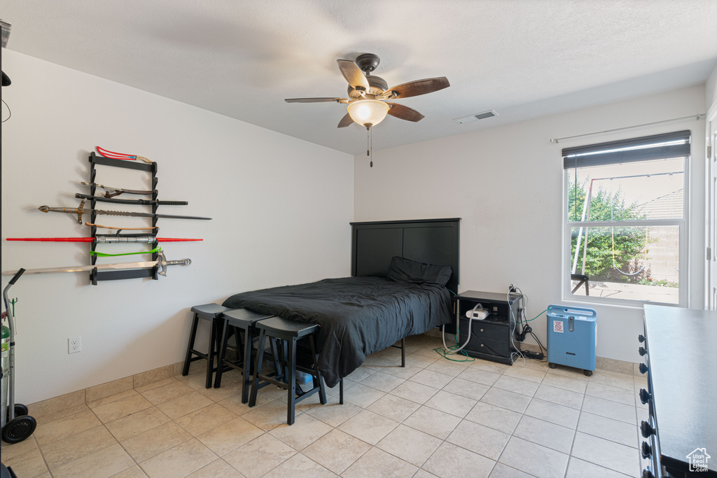 Bedroom featuring a ceiling fan and light tile patterned flooring