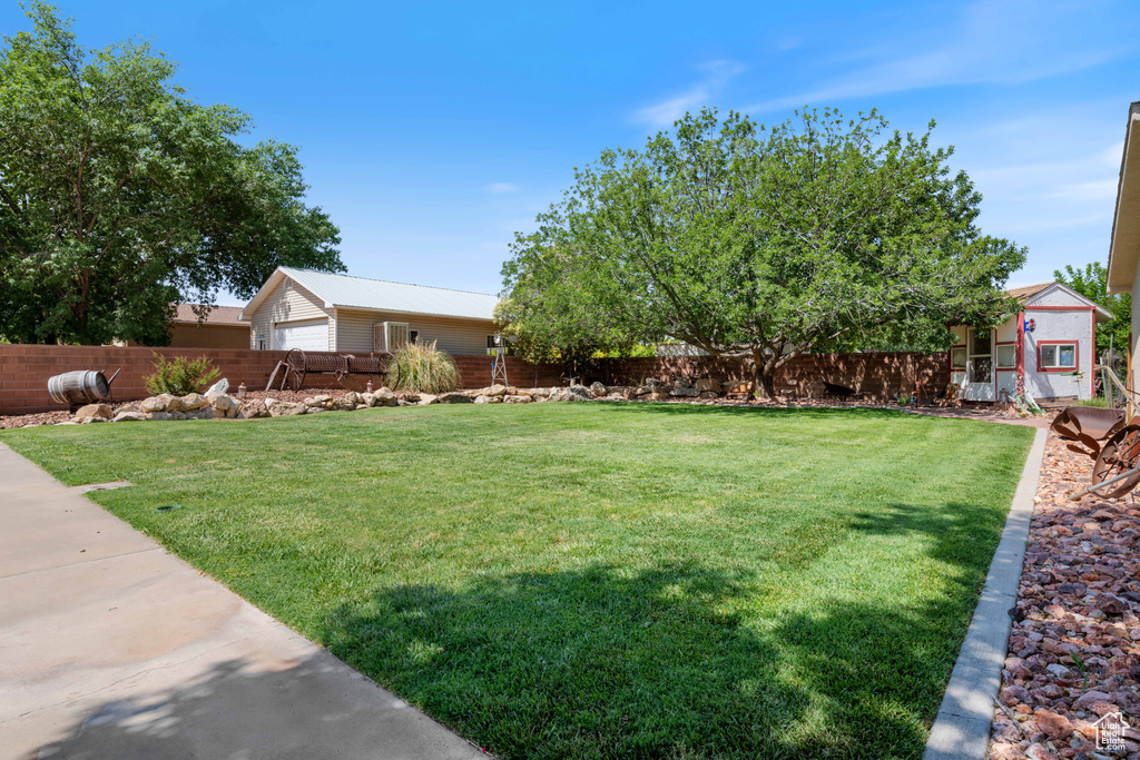 View of yard featuring an outbuilding and a detached garage