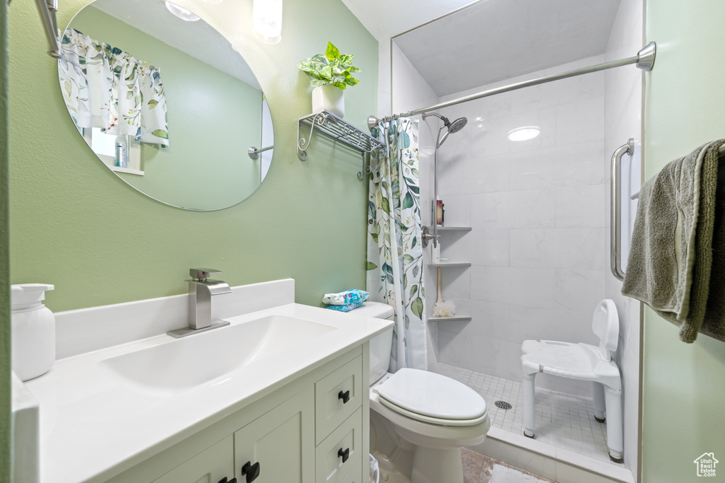 Full bathroom with vanity and tiled shower