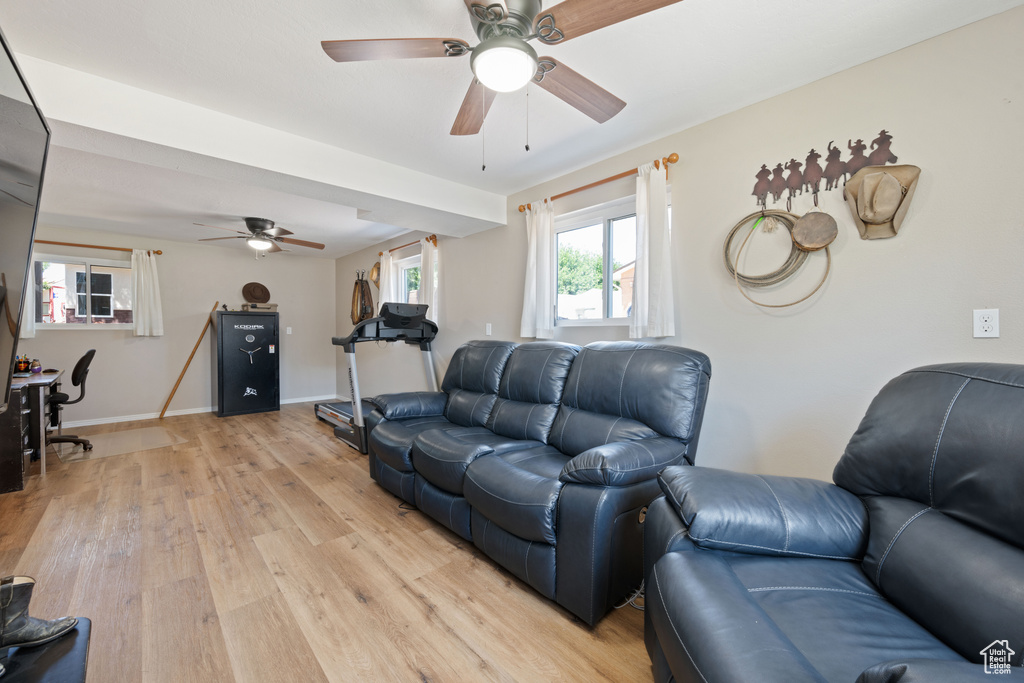 Living room with light wood-style floors and ceiling fan
