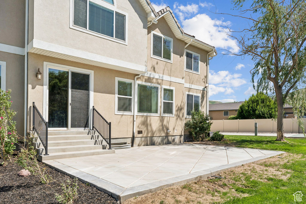 Back of property featuring stucco siding and a patio area