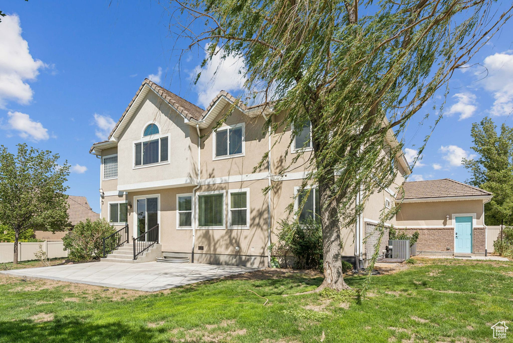 Back of house featuring stucco siding, a patio, and entry steps