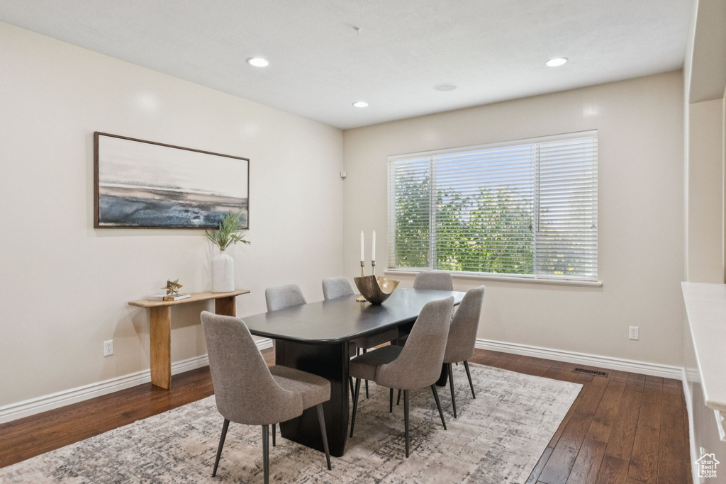 Dining room with hardwood / wood-style flooring and recessed lighting
