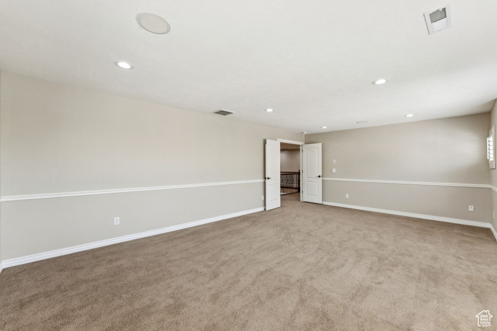 Unfurnished room featuring recessed lighting and light colored carpet