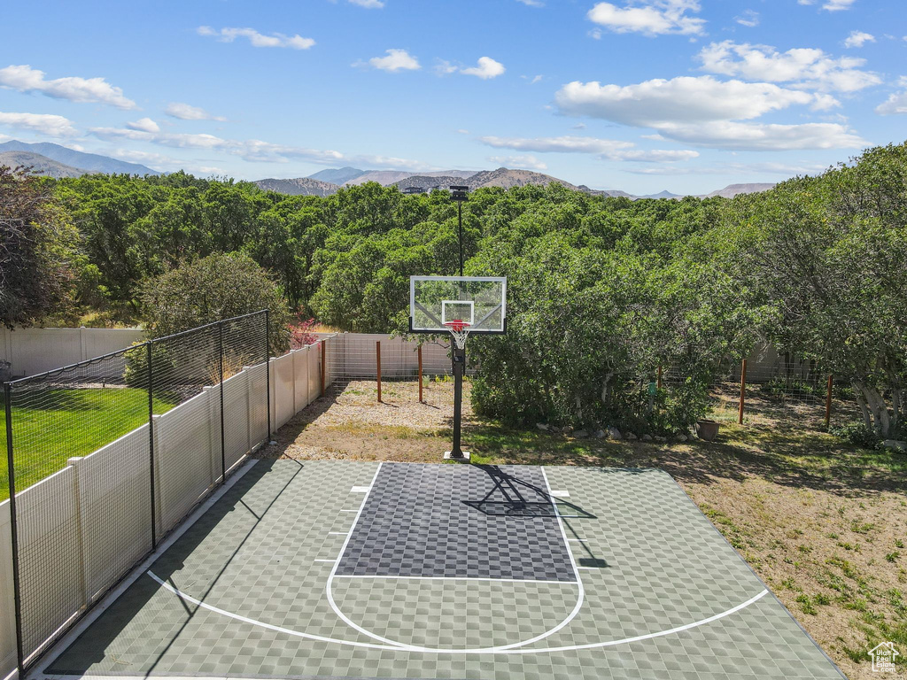 View of basketball court with basketball hoop and a mountain view