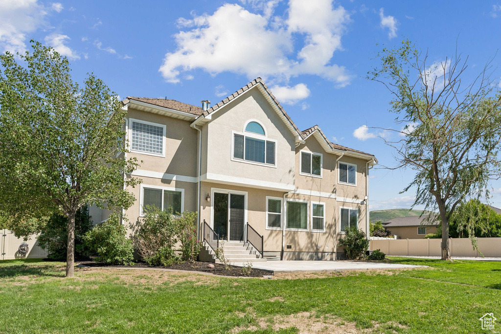Rear view of property with stucco siding and a patio