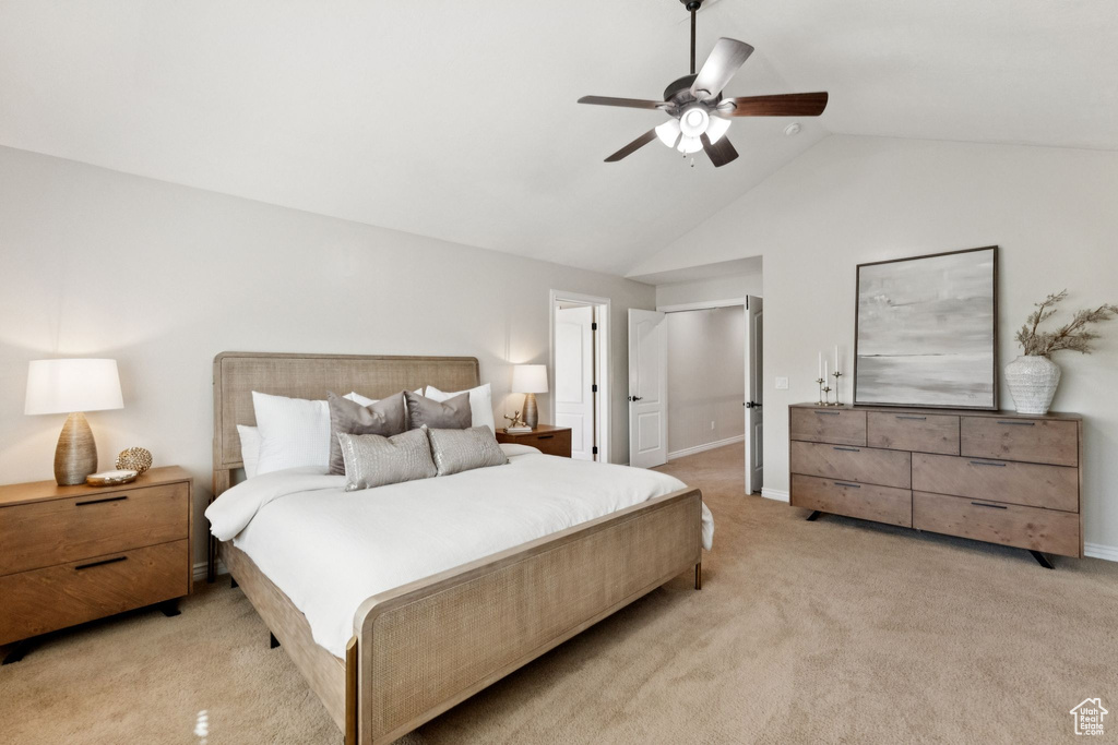Bedroom featuring light colored carpet, ceiling fan, and high vaulted ceiling