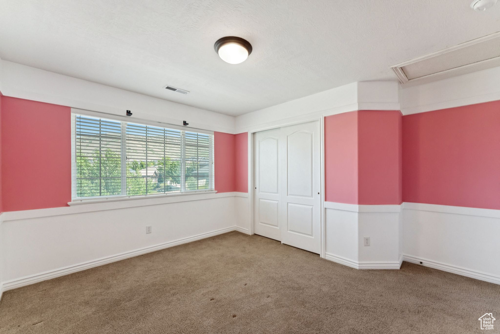 Unfurnished bedroom featuring carpet floors and a closet
