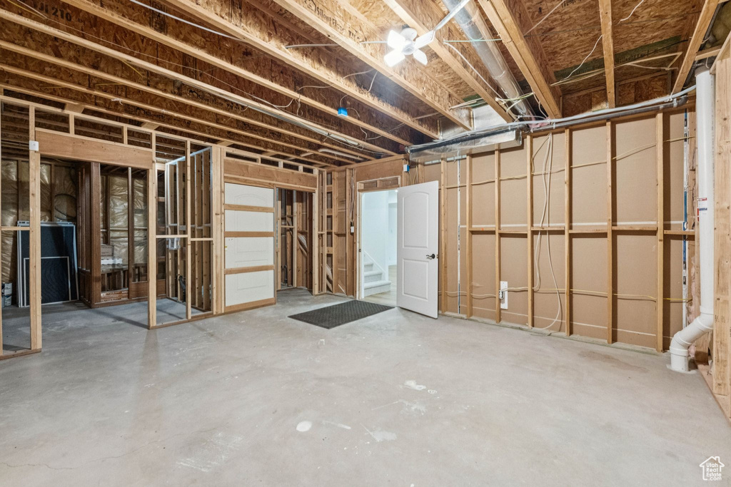 Unfinished below grade area featuring stairway