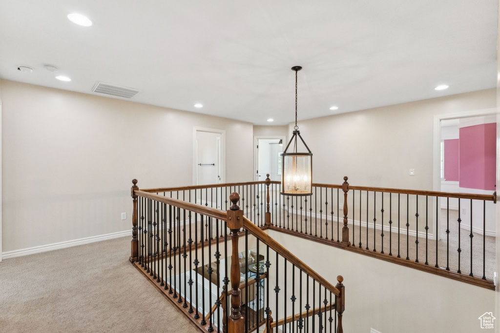 Corridor with recessed lighting, carpet floors, and an upstairs landing