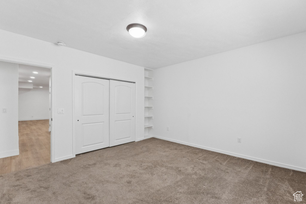 Unfurnished bedroom with carpet floors and a closet