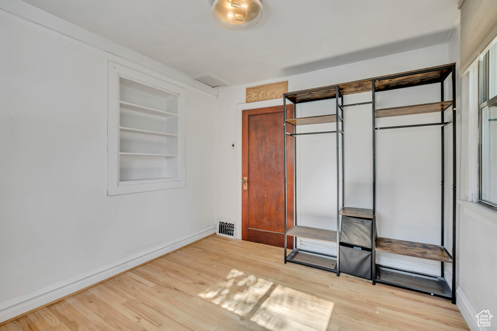 Unfurnished bedroom with light wood-type flooring and a closet