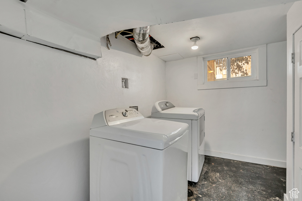 Laundry area with washer and clothes dryer and baseboards