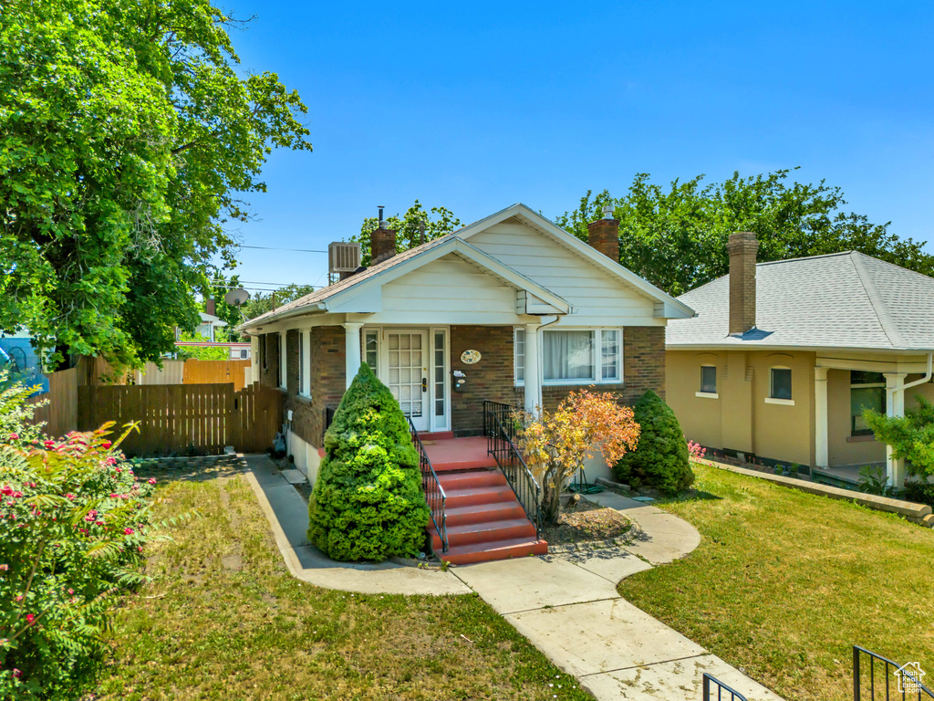 Bungalow featuring a chimney and covered porch