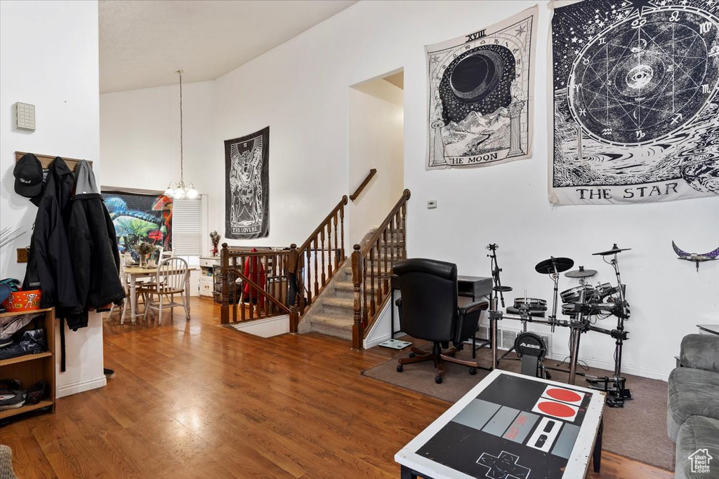 Office space featuring a chandelier and wood finished floors