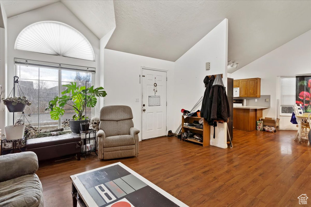 Living room with vaulted ceiling and wood finished floors