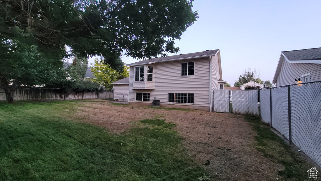 Back of property with a fenced backyard and a gate