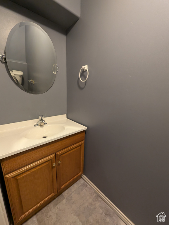 Bathroom featuring vanity and baseboards
