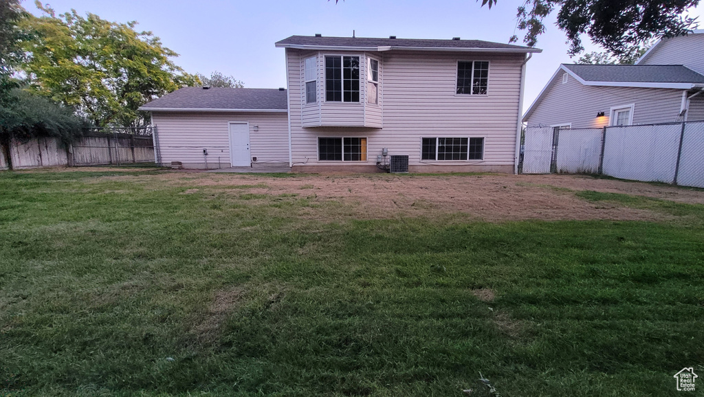 Rear view of property with a fenced backyard