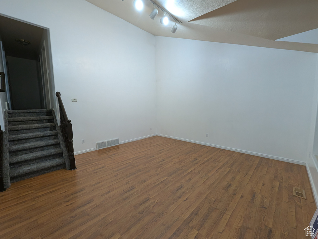 Empty room with wood finished floors and stairs