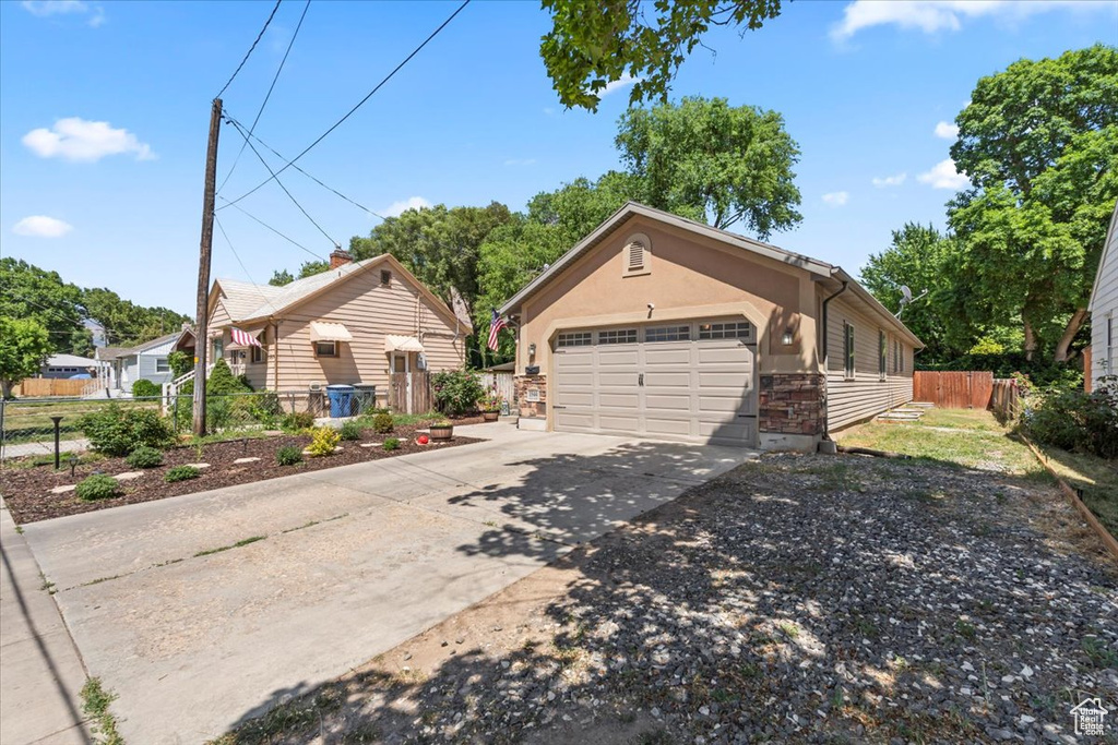 View of front facade with driveway and a garage