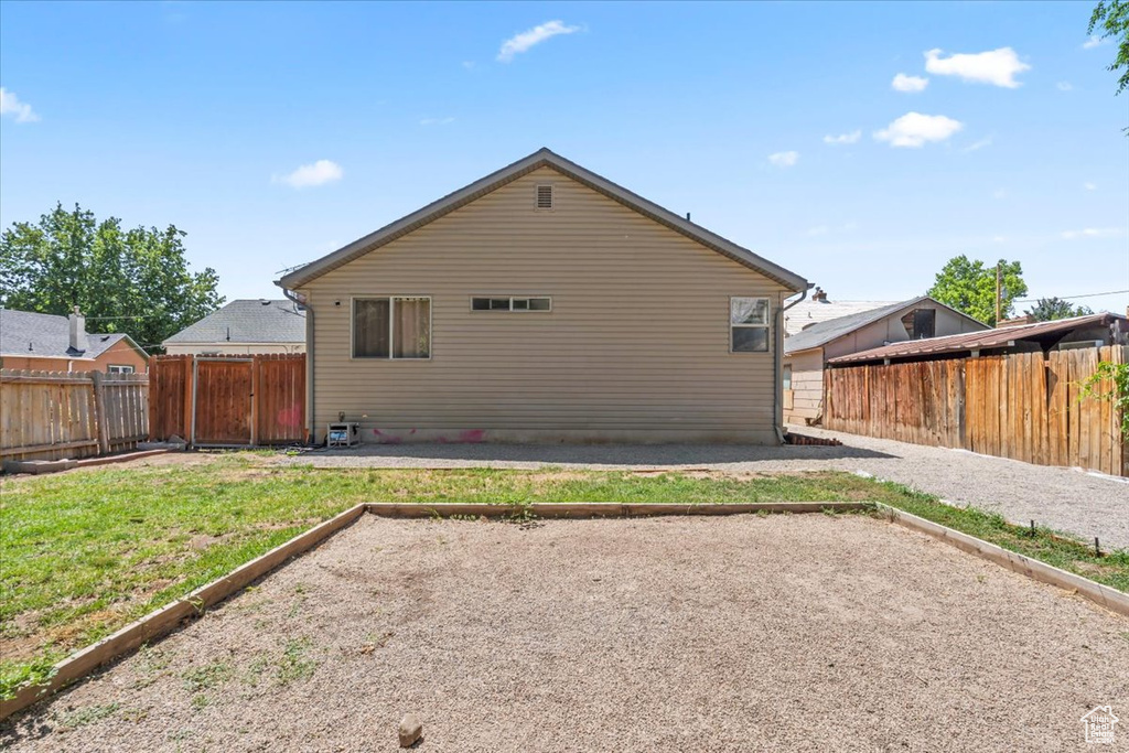 Rear view of property with a fenced backyard