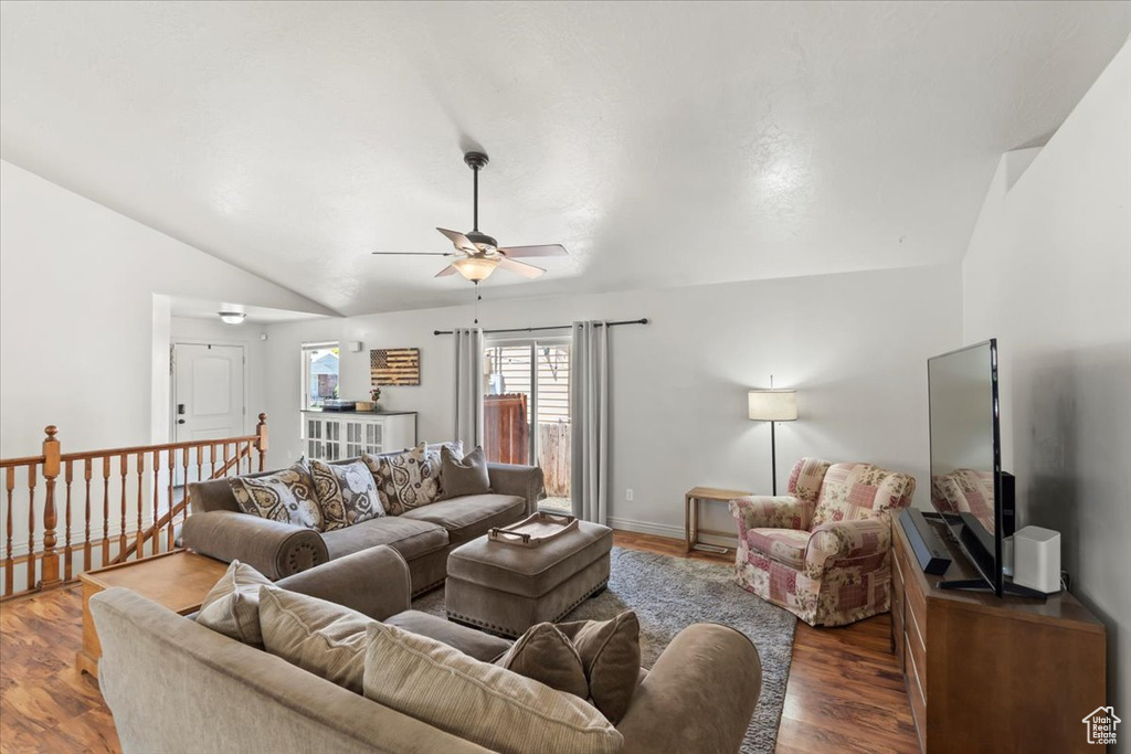 Living area with lofted ceiling, ceiling fan, and wood finished floors