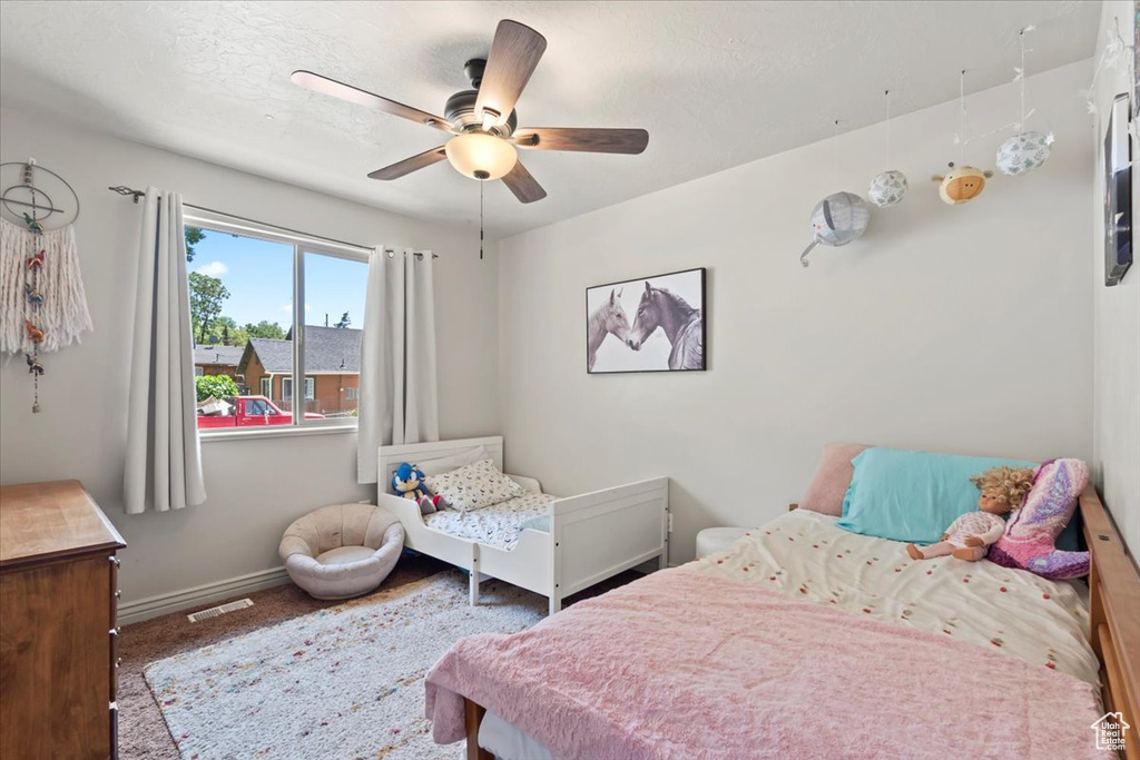 Bedroom featuring a ceiling fan and carpet flooring