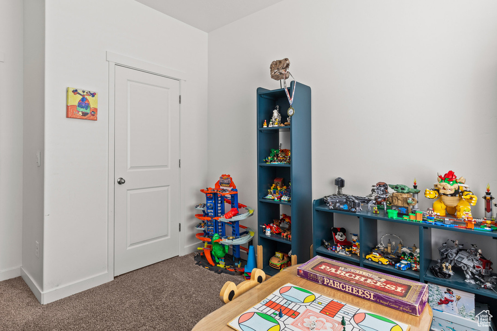 Rec room with carpet and baseboards