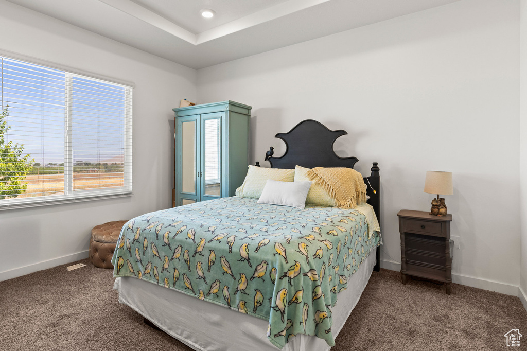 Carpeted bedroom featuring baseboards