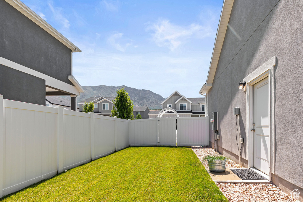View of yard with a gate and a mountain view