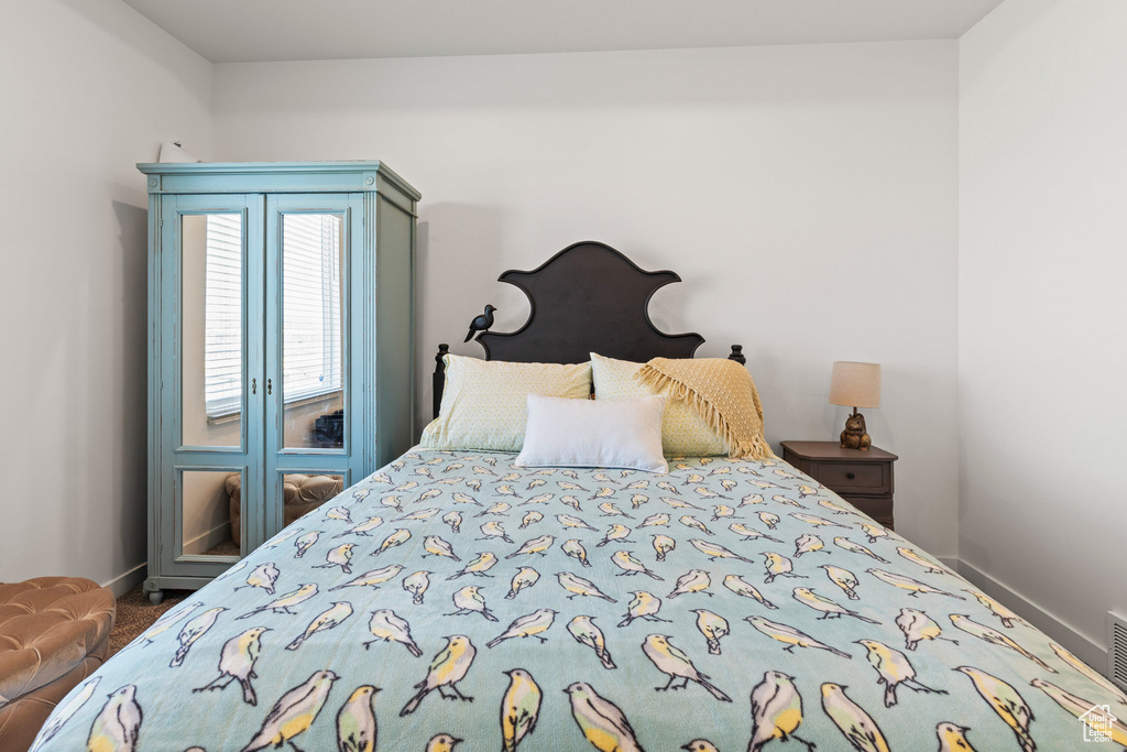 Carpeted bedroom featuring baseboards