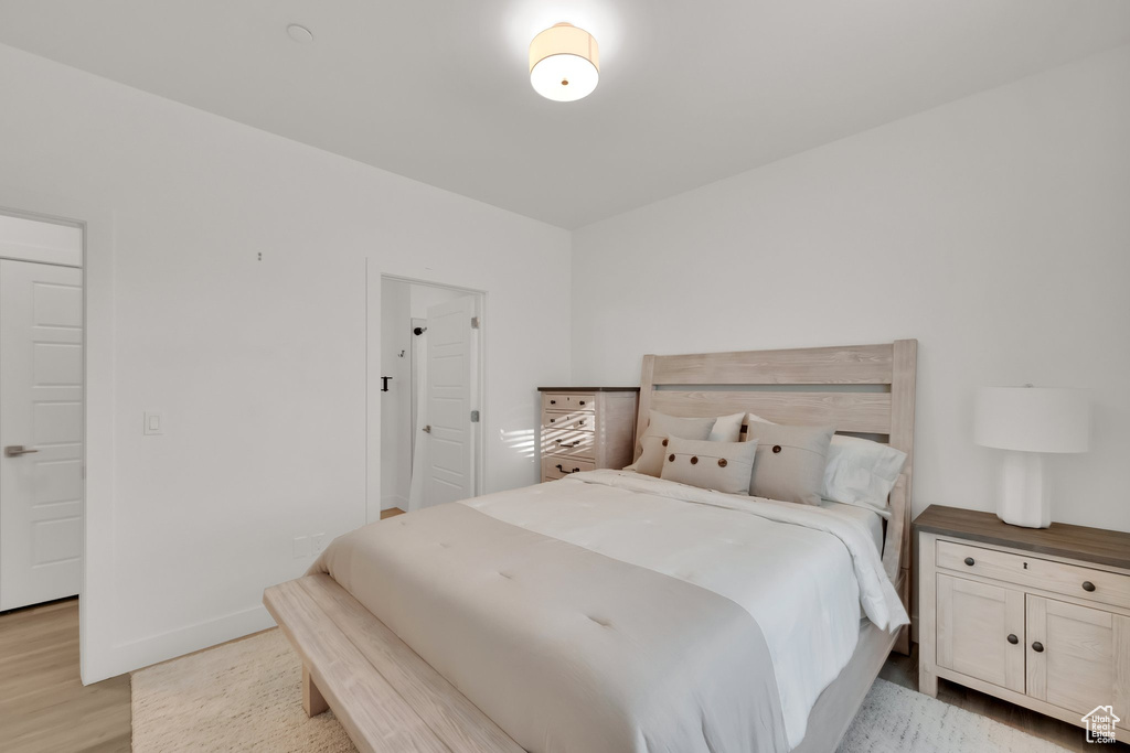 Bedroom with light wood-style flooring and baseboards
