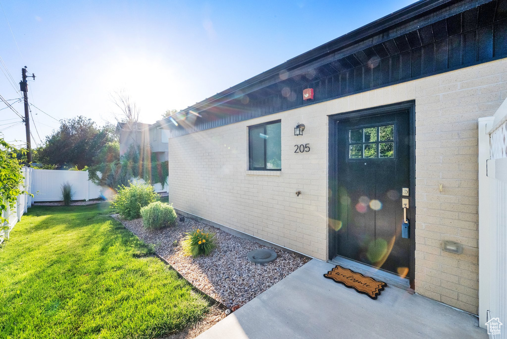 View of exterior entry featuring brick siding