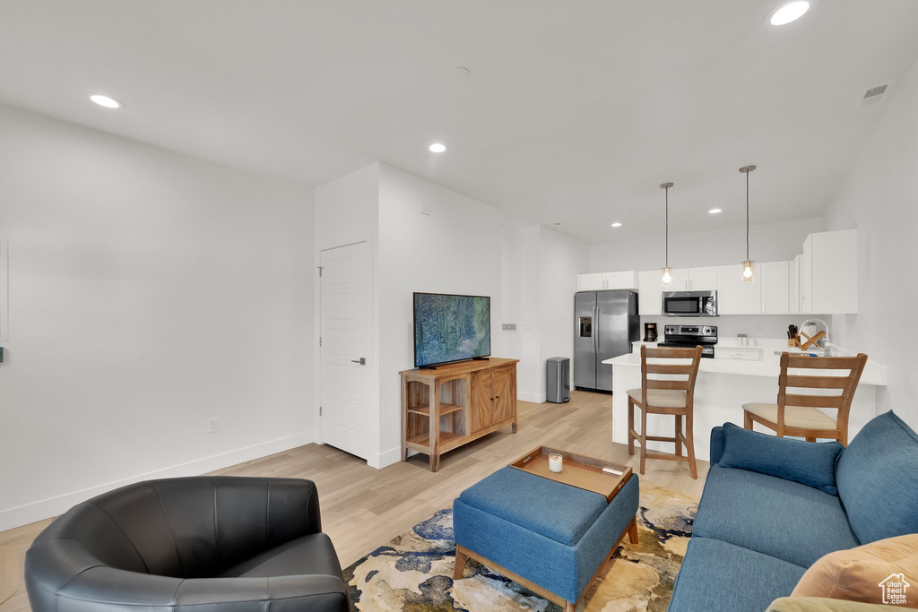 Living room featuring light wood finished floors and recessed lighting
