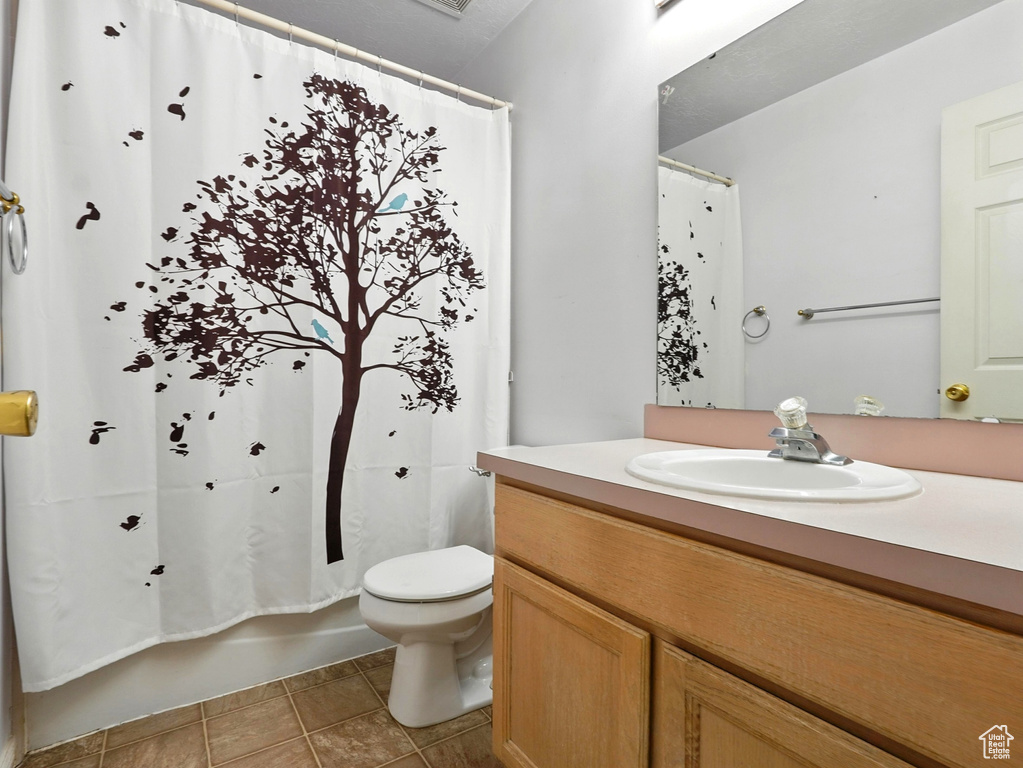 Full bath featuring vanity and tile patterned flooring