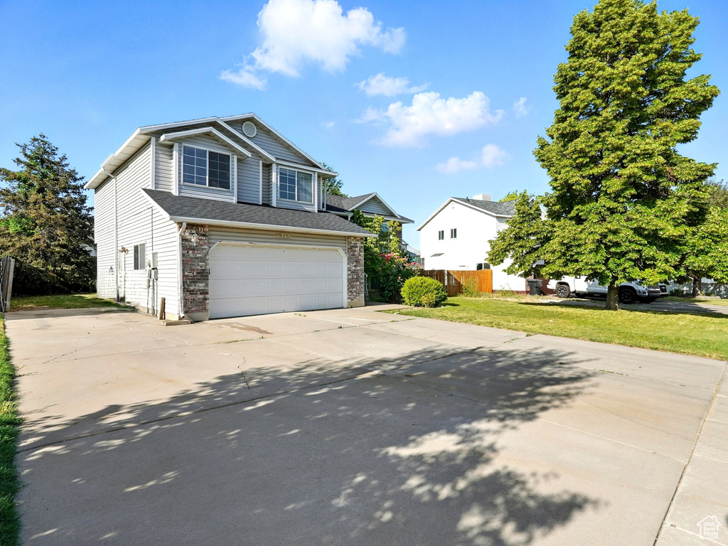 Traditional-style home with driveway and an attached garage
